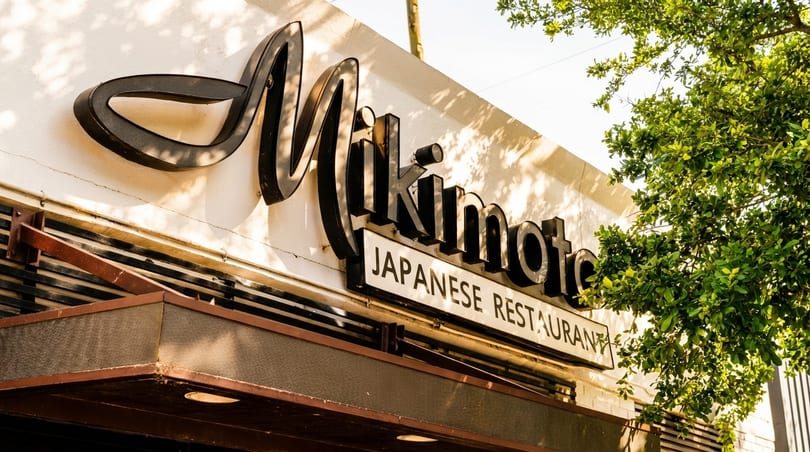 Exterior view of the Mikimoto Japanese Restaurant sign on a sunny day.